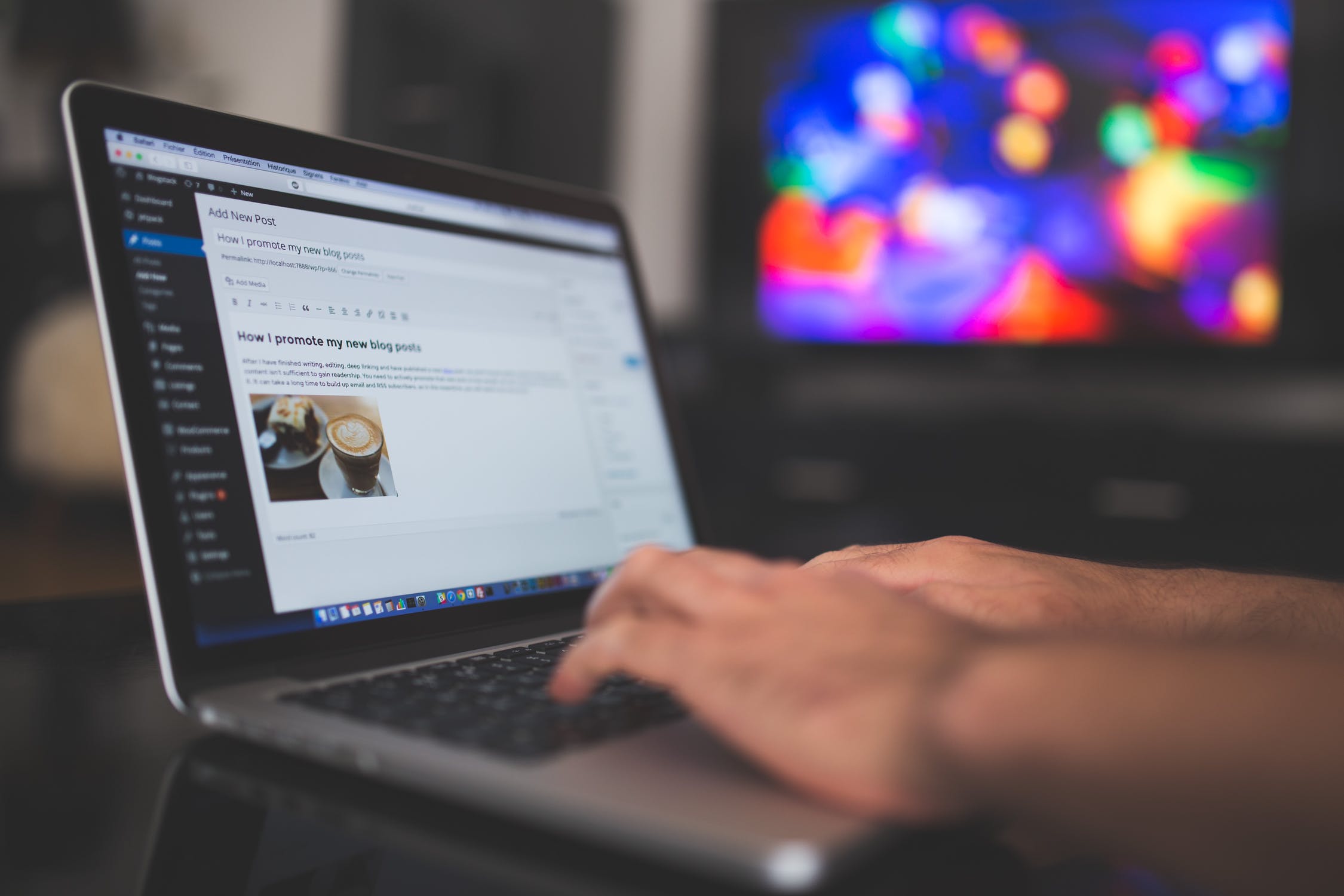 Hands typing on a laptop with a blog post on the screen representing Content Marketing.