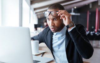 Image of businessman looking at computer surprised to illustrate the important of how to speed up a website