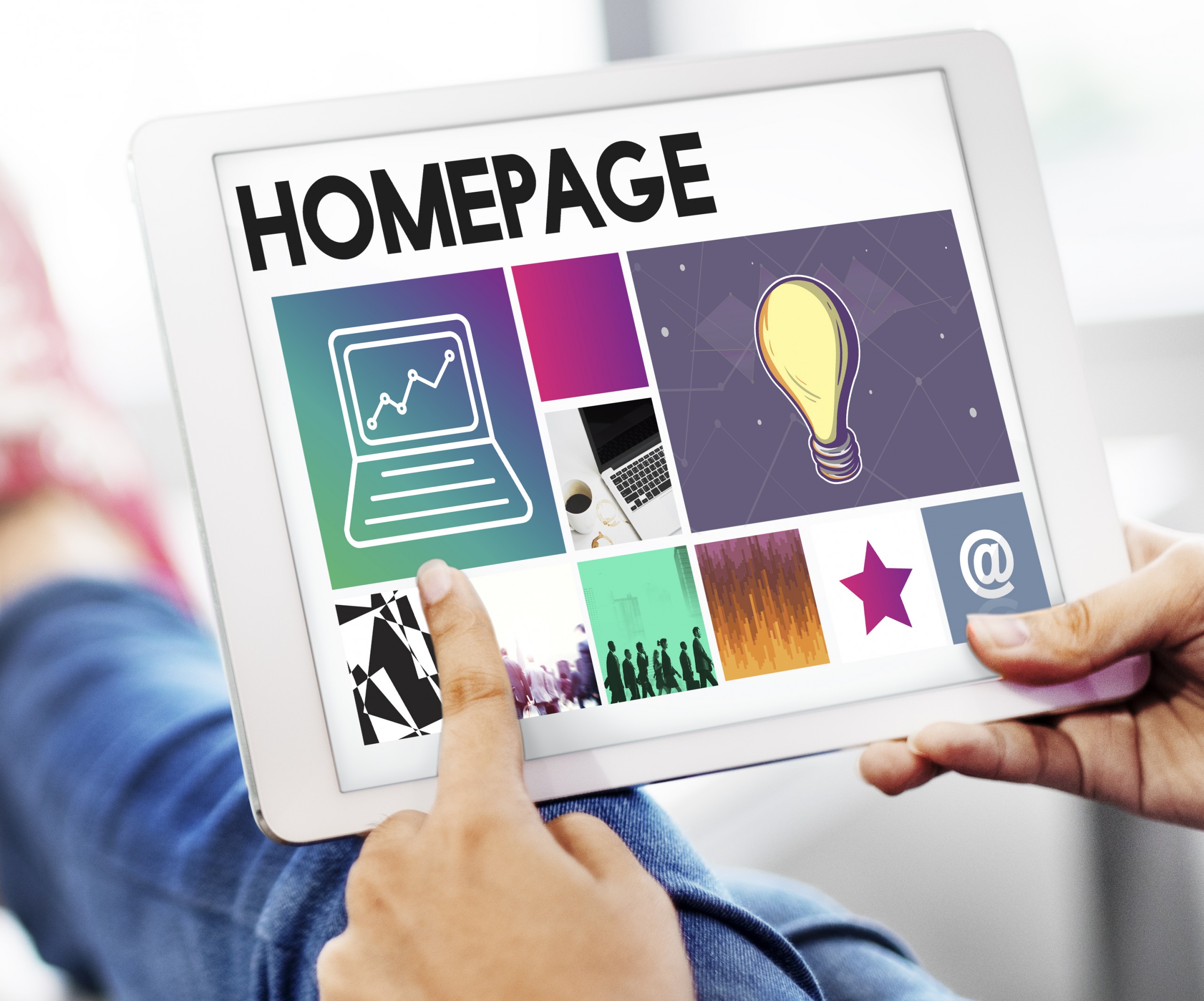 Person browsing a website with bright pictures on a tablet.