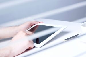 hearing impaired person accesses a website using a tablet. As the number of Federal Website Accessibility lawsuits in the US continues to grow, it will be increasingly important to get your website in compliance.