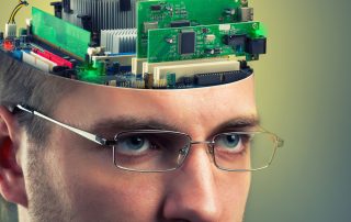 Confident businessman with computer in head representing how closely humans and machines work together.