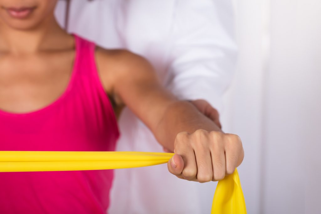 Physical therapy patient stretching with a band