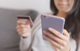 Woman shops with her mobile phone. Google's Ads is incorporating its Shoppable Ads into Google Images search results for increased traffic and lower cpc.