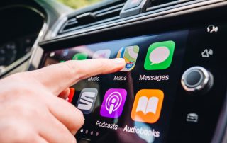 Woman pushing the Google Maps app on her car's Apple CarPlay dashboard.