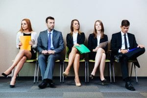 Image of people waiting for job interview to represent whether brands should hire a freelancer or agency for their digital marketing needs.