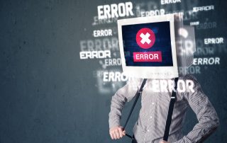 Business man with pc monitor on his head and error messages darker background