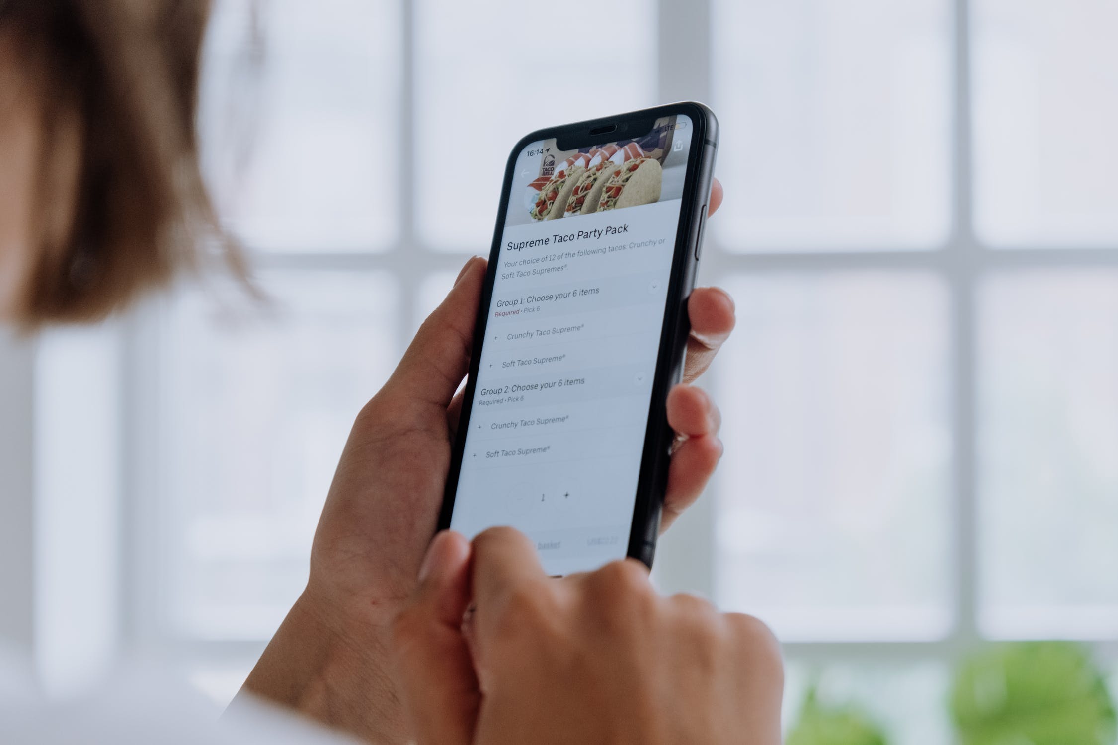 Woman looking at a mobile phone at search results.