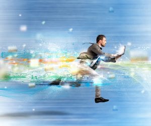 Businessman in a suit with a laptop running fast signifying website loading speed. 