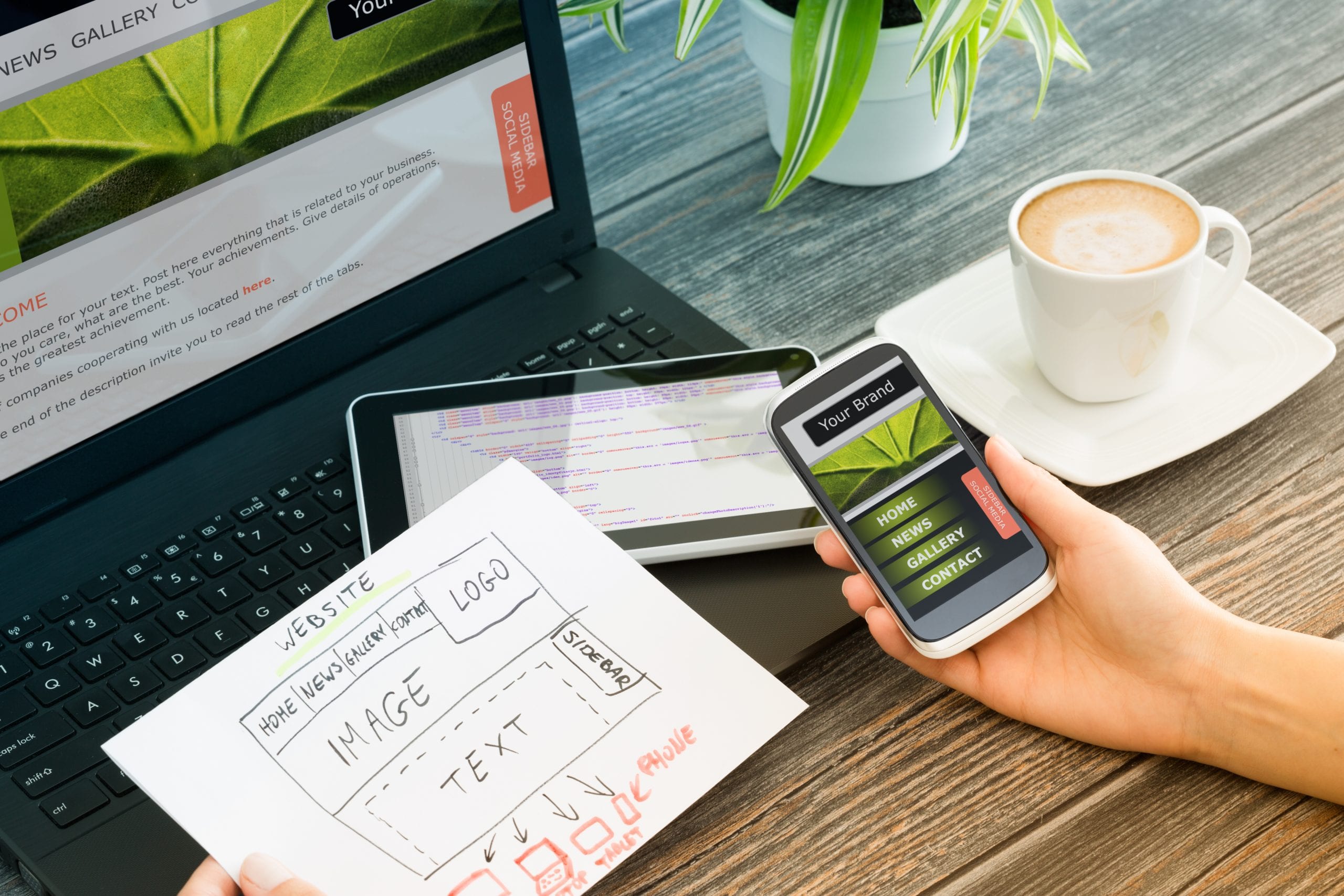 Responsive web design Website designer looking at images and using mobile device to work on SEO for images