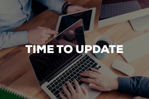 "time to update" typography over a photo of two people working on a laptop and tablet