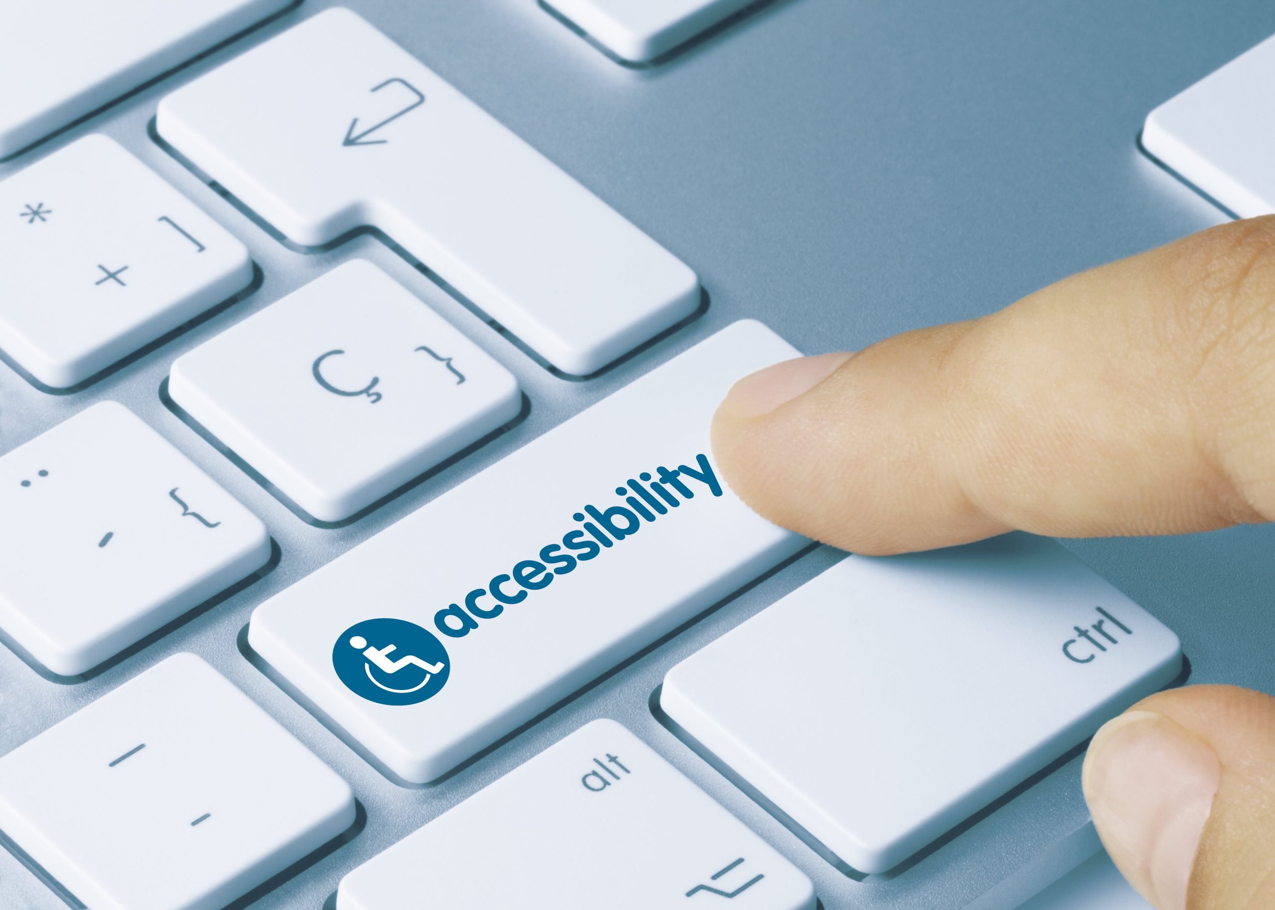 person pressing accessibility button on computer keyboard