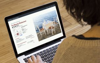 woman looking at a business directory listing displayed on a laptop