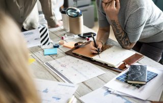 people standing around a table creating a content strategy for business